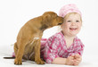 cute little girl playing with her puppy dog