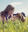 girl with her puppy in the grass